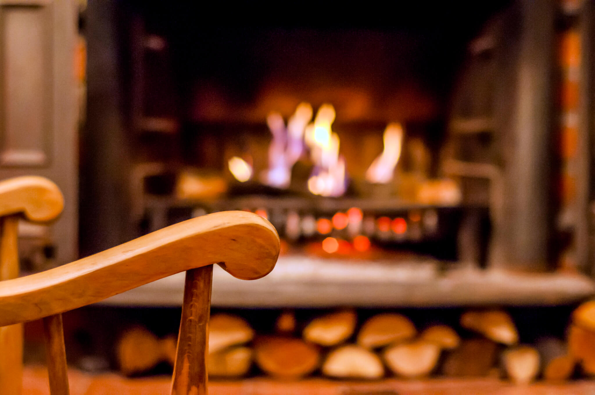 Home comfort. Rocking chair near the fireplace. Photo of interio